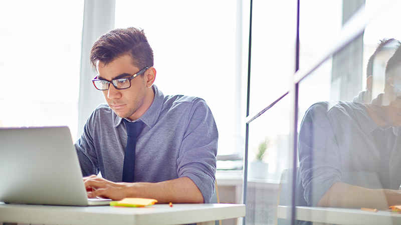 Man working on his laptop. Man working on his laptop.
