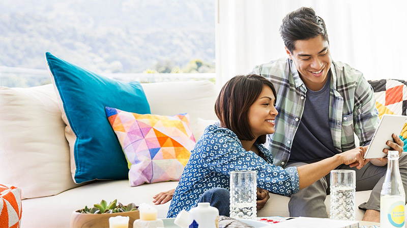 A couple paying online using tablet