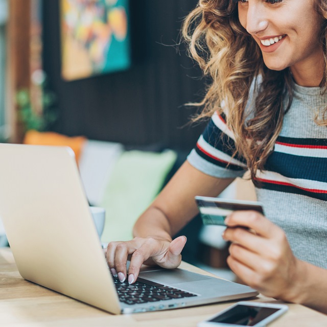 person on laptop while drinking coffee