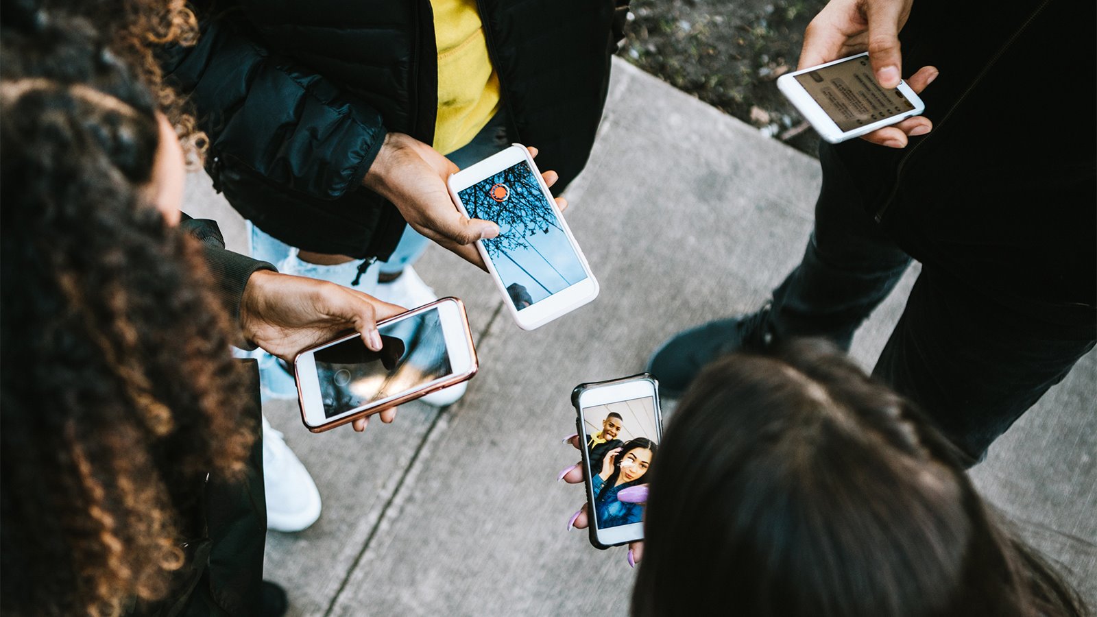 people standing using phones