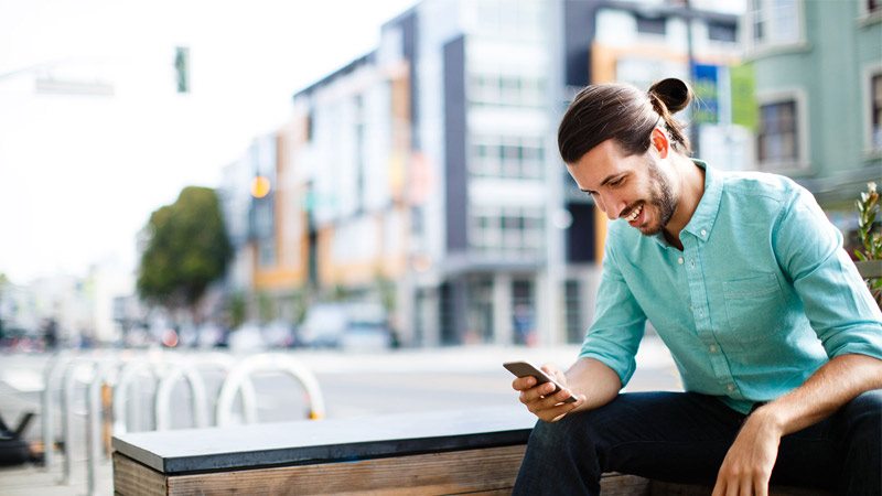 Person sitting using phone