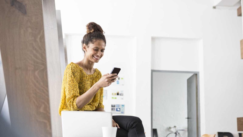 Person smiling looking at phone