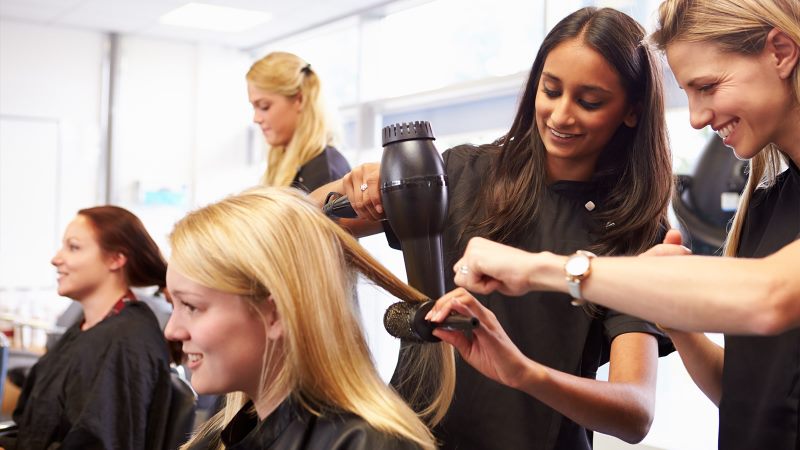 person blow drying another persons hair