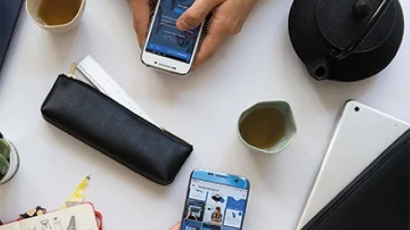 desk with two people on their phone